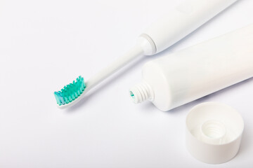 electric toothbrush and toothpaste isolated on white background. Flat lay. Oral hygiene. Oral care kit. Dentist concept. Place for text. Place to copy.