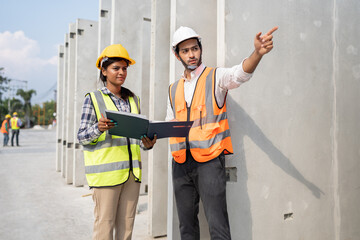 India engineer woman and Asia engineer man working with document at precast site work