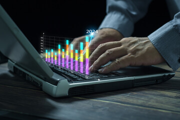 Businessman analyzing digital virtual graphics profit forecasting company business growth 2024....