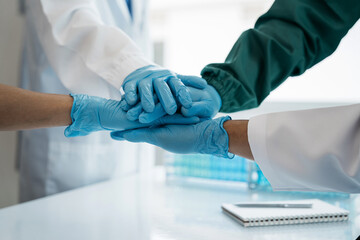 Doctors shaking hands in unity at the hospital.