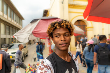 Portrait of a man with African-American features. Black boy. Afro hair. Colombian person