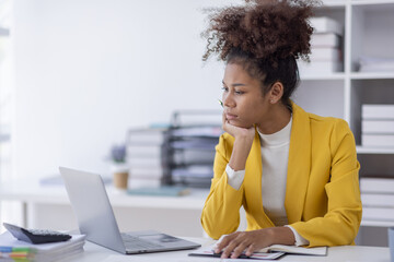 Young business african american woman office worker analyst sitting at desk working on laptop...