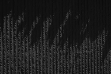 the black texture of a plaster or wall with small indentations.