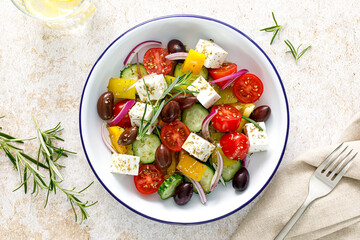 Greek salad. Vegetable salad with feta cheese, tomato, olives, cucumber, red onion and olive oil. Healthy vegetarian mediterranean diet food. Top view - 604934755