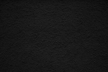the black texture of white plaster or a wall with small indentations.