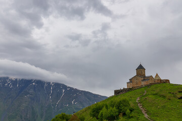 Fototapeta na wymiar Gergeti Trinity Church near the Stepantsminda village in Georgia ,At an altitude of 2170 meters, under Mount Kazbek or Kazbegi, 
