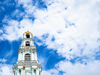 blue sky with white clousds over belltower of orthodox cathedral