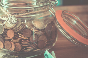 Close up of jar full of coins. Savings money for travel or dreams to realize. Euro and europe...