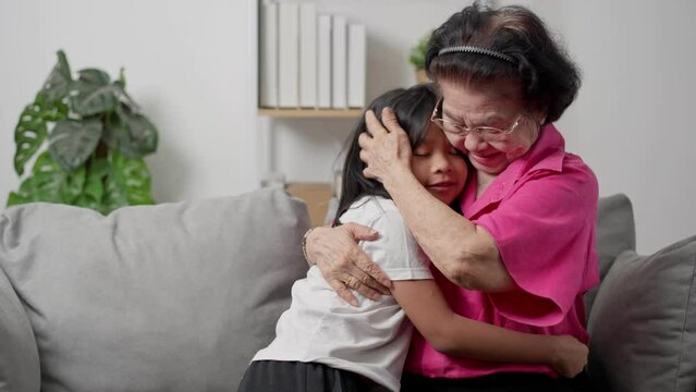 Happy old grandmother surprised after meeting granddaughter and embracing little granddaughter with love, little grandchild hug senior grandparent, show love and gratitude, family unity concept