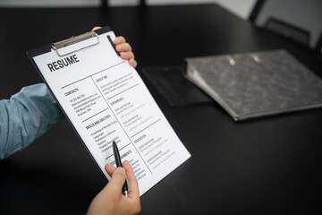 Obraz premium Examiner reading a resume during job interview at office Business and human resources concept.