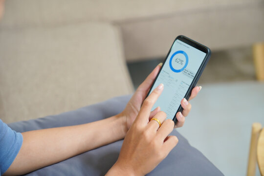 Woman checking Financial on smartphone Human hand holding mobile phone working from home