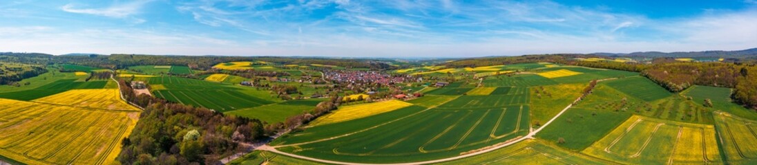 Fototapeta na wymiar Panoramic aerial view of the Taunus landscape with flowering rapeseed fields near Wallrabenstein - Germany