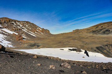 A view of the Kilimanjaro crater depression from the Kibo crater rim showing temporary snow deposits, Tanzania