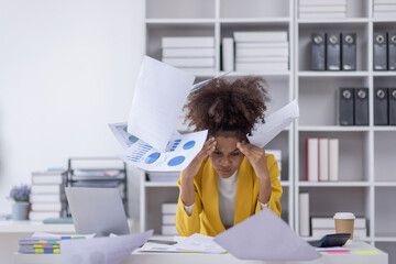 Portrait of tired business african american woman work with documents tax laptop computer in...