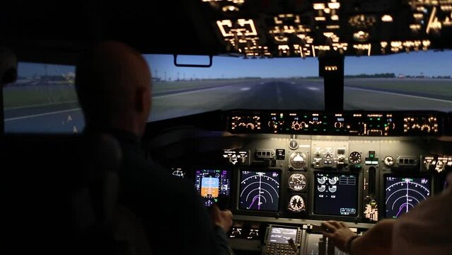Two pilots are taking off an airplane at dusk. The pilot turns on the engine and fixes the altitude level using the control panel instruments and navigation. Back view. Flight control concept.