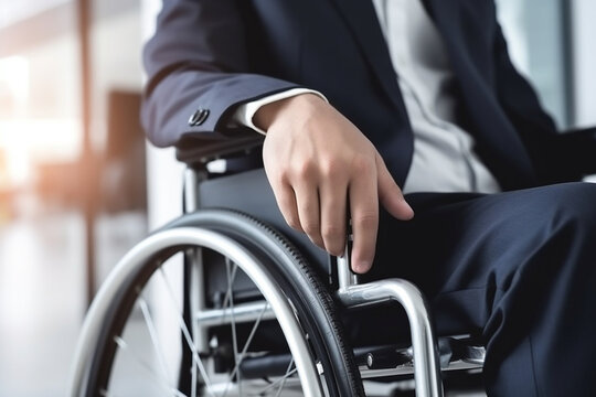 Businessman in wheelchair hand on wheel close up office interior on background