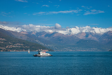 Scenic view of northern branch of Lake Como, Italy with a sailing boat and the ferry 