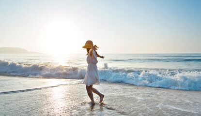 Young woman having fun walking on seaside.