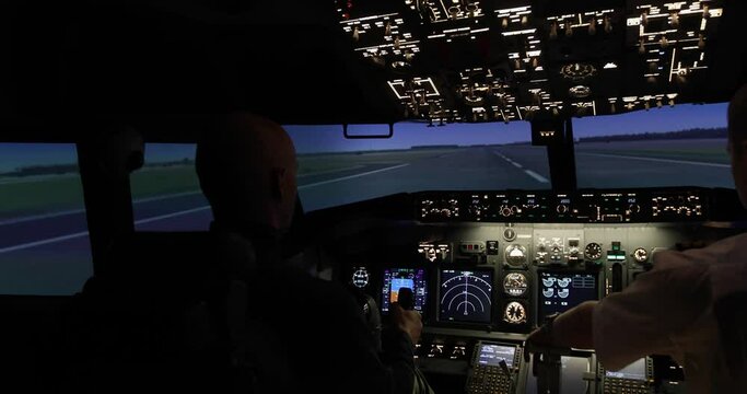 Airplane flight simulation. Two pilots in the cockpit. Plane take off. Aircraft control during training. Airplane flight concept.