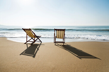 Two chairs on the beach.