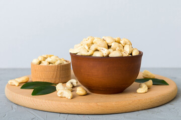 cashew nuts in wooden bowl on table background. top view. Space for text Healthy food