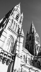 Obraz premium The Gothic spire of an Anglican church in Cork, Ireland. Neo-Gothic Christian religious architecture. Cathedral Church of St Fin Barre, Cork - One of Ireland’s Iconic Buildings. Monochrome.