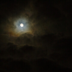 Naklejka na ściany i meble Full moon in the dark night sky with clouds.