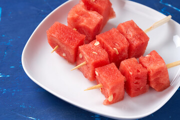 Finger food sticks with with watermelon cubes.