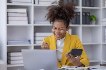 Excited african american woman sit at desk feel euphoric win online lottery, happy black woman overjoyed get mail at tablet being promoted at work, biracial girl amazed read good news at computer