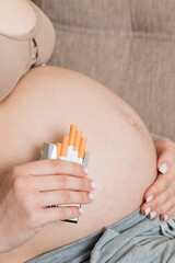 Pregnant woman with cigarette at home. mother smoking concept