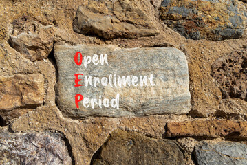 OEP symbol. Concept words OEP Open enrollment period on beautiful big stone in stone wall. Beautiful stone wall background. Medical and OEP Open enrollment period concept. Copy space.
