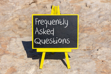 FAQ frequently asked questions symbol. Concept words FAQ frequently asked questions on black chalk...