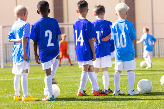Youth soccer football team. Soccer team practicing penalty kick. Group photo. Soccer players standing together at training. Teammates at soccer training drill