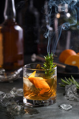 Cocktail Old Fashioned Negroni. The astringency of the whiskey is leveled by sugar, and the herbal tincture and smoking rosemary add flavor and original notes. Served with ice and orange