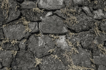 Texture of a stone wall. Old castle stone wall. Pattern gray color of modern style design decorative uneven cracked real stone wall surface with cement. Brick texture for wallpaper or background.