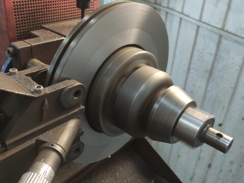 Car brake disc grinding on a lathe machine.  Brake discs runout elimination