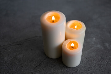 Fototapeta na wymiar White candles on a gray background