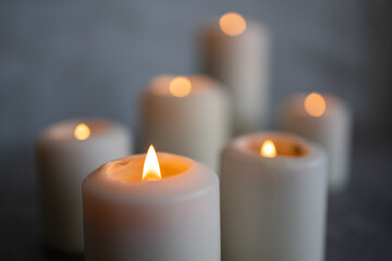 White candles on a gray background