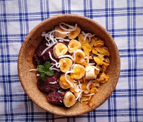 iced açaí bowl with banana, grated coconut and cereals  typical brazilian food