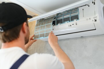 Service man is cleaning, repair and maintenance of air conditioner. - obrazy, fototapety, plakaty