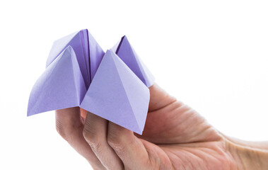 People hand holding a origami fortune on white background