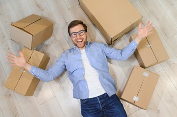 Happy man with cardboard box in new home