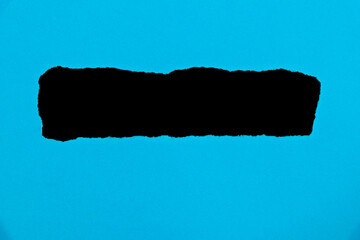 Blue torn paper on black background