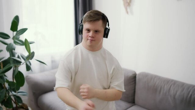 Funny guy with down syndrome dancing at home, feel total freedom