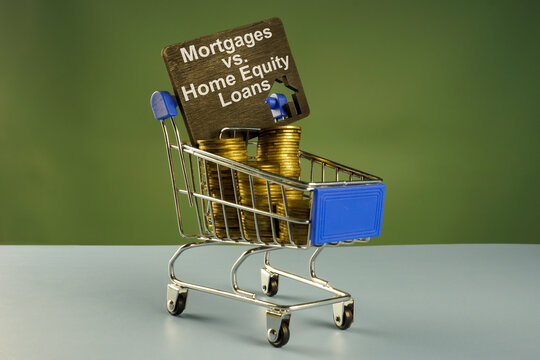 Shopping cart with coins and inscription Mortgage vs. Home Equity loan.