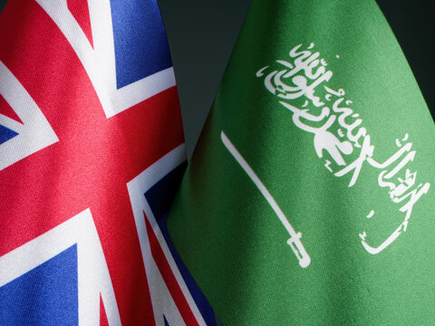 Flags of Great Britain and Saudi Arabia side by side.