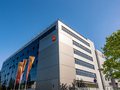 Building exterior of the pharmaceutical company GSK in Saxony. Modern industrial architecture and production hall of medical and consumer products.