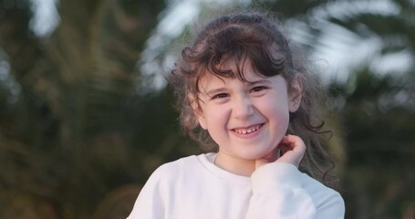 The moments of a little girl looking at the camera and making adorable facial expressions that resemble anger and grumpiness