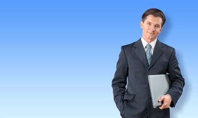 Positive modern young business man with laptop