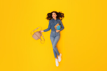 Fototapeta na wymiar Student Lady Holding Backpack And Study Materials Over Yellow Background